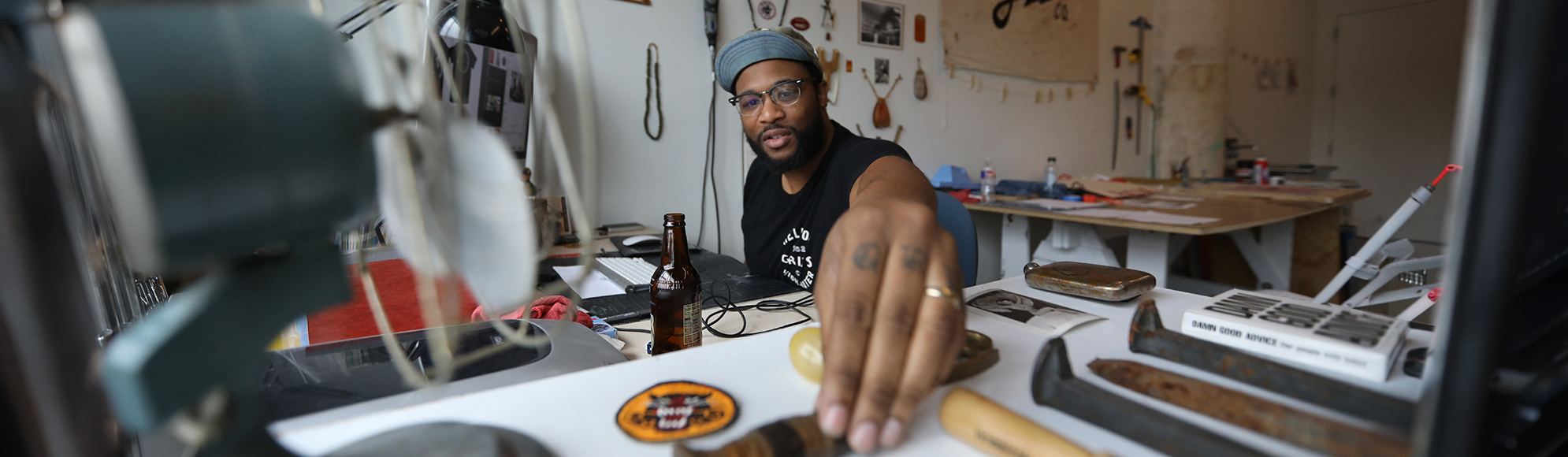 An artist examines artifacts in their studio
