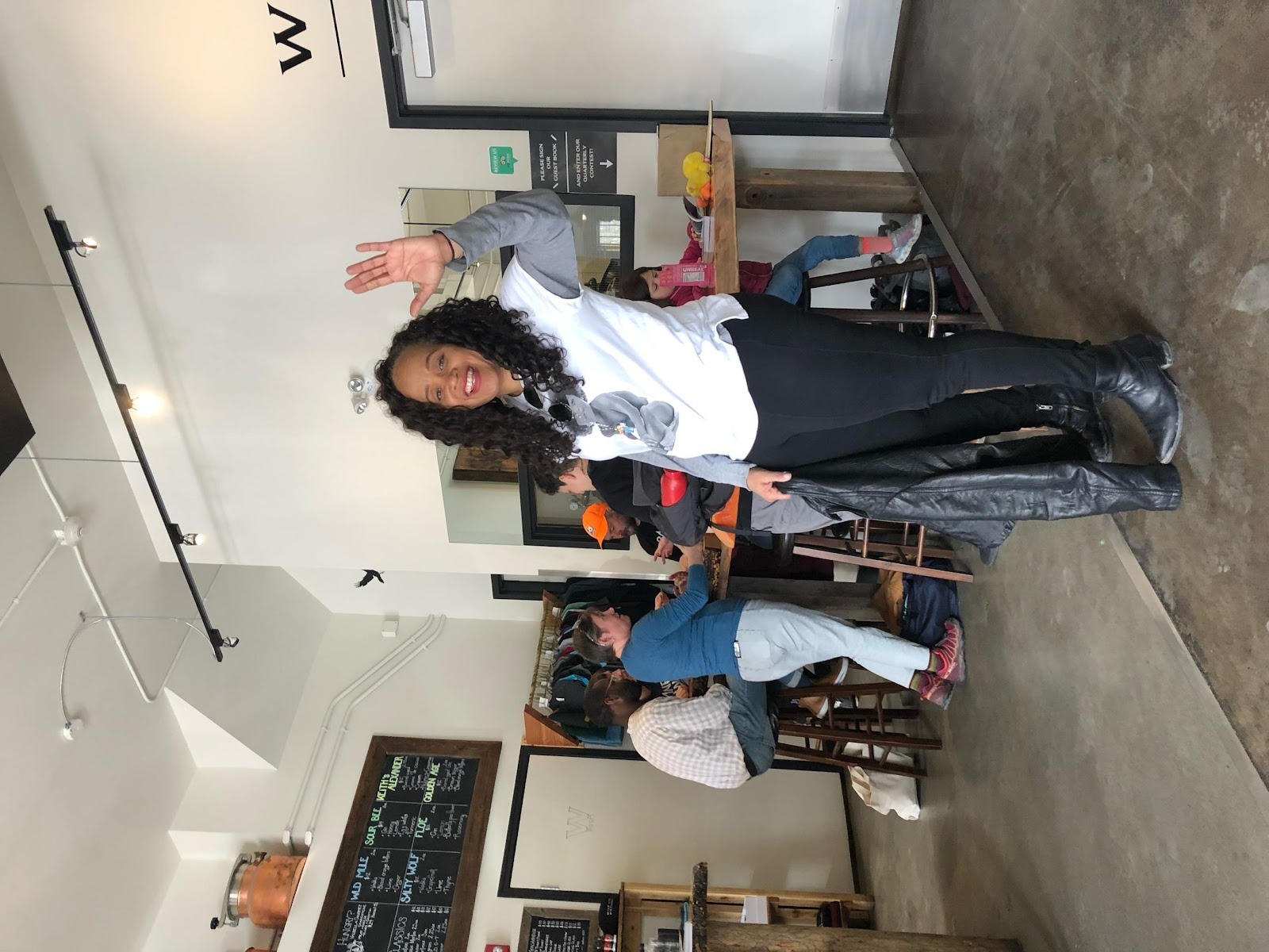 A person standing in a room with other people

AI-generated content may be incorrect.