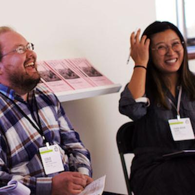 Two workshop attendees laughing and smiling