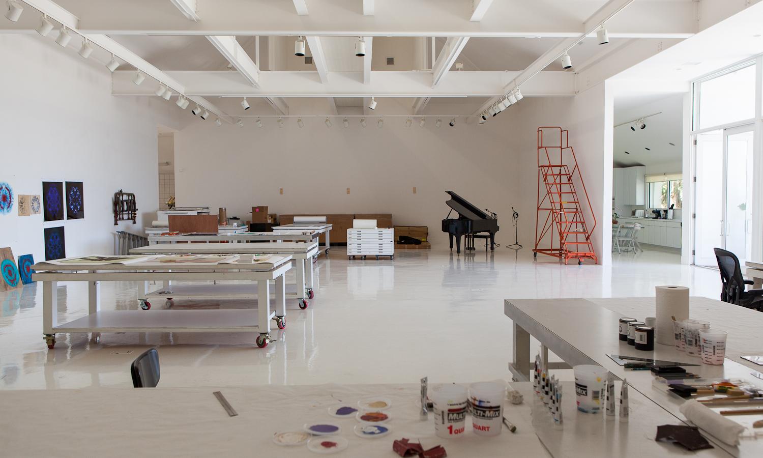 Interior of large white room with tables and equipment and a catwalk
