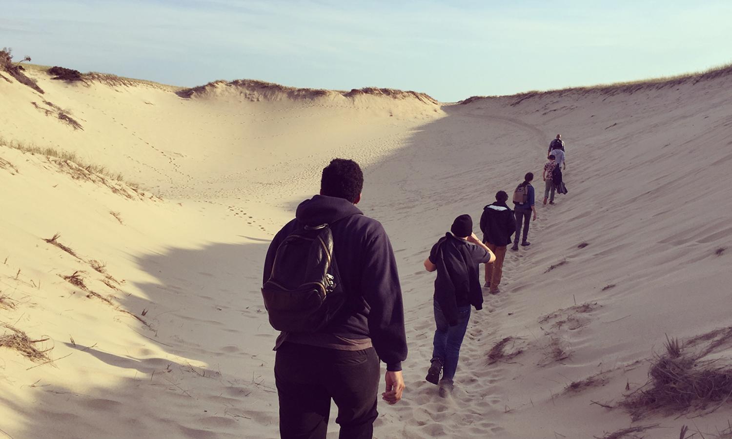 Fellows hiking through the dunes of the Cape Cod National Seashore