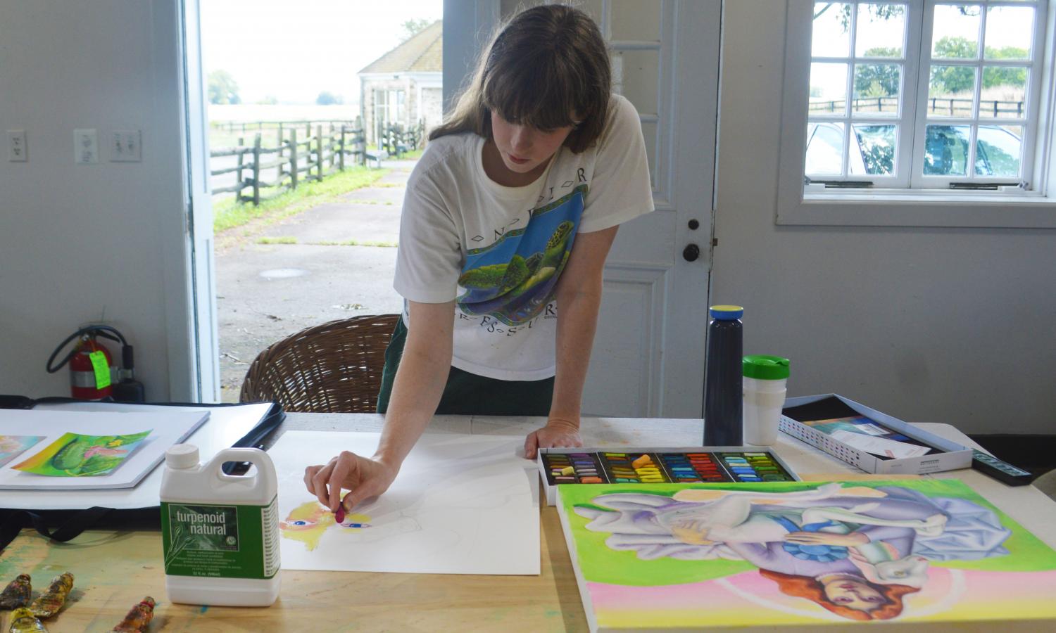 Emma Steinkruas, working on a painting in her studio