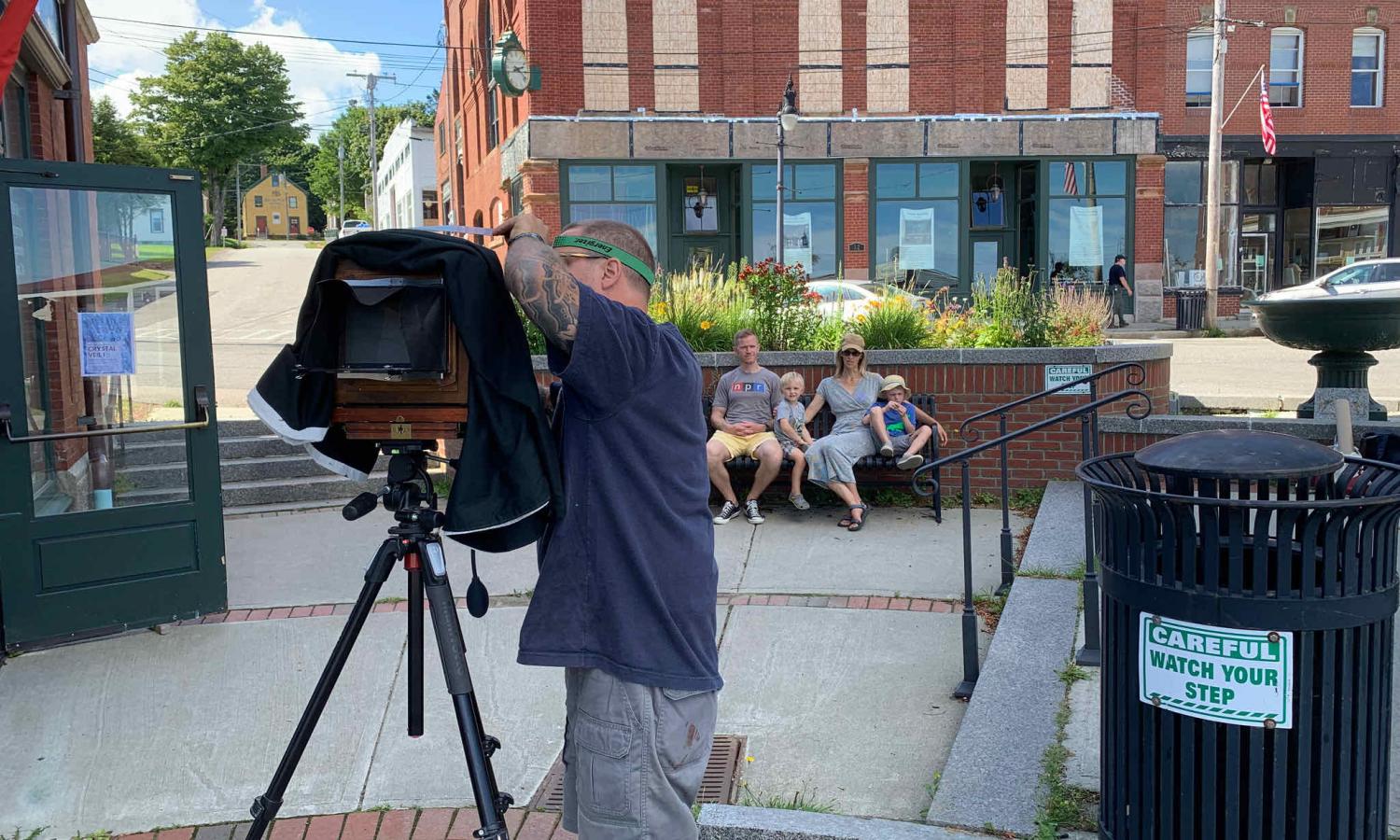 A family poses outside of the Tides institute for a tin-type portrait photograph taken by John DiMartino, Jr.