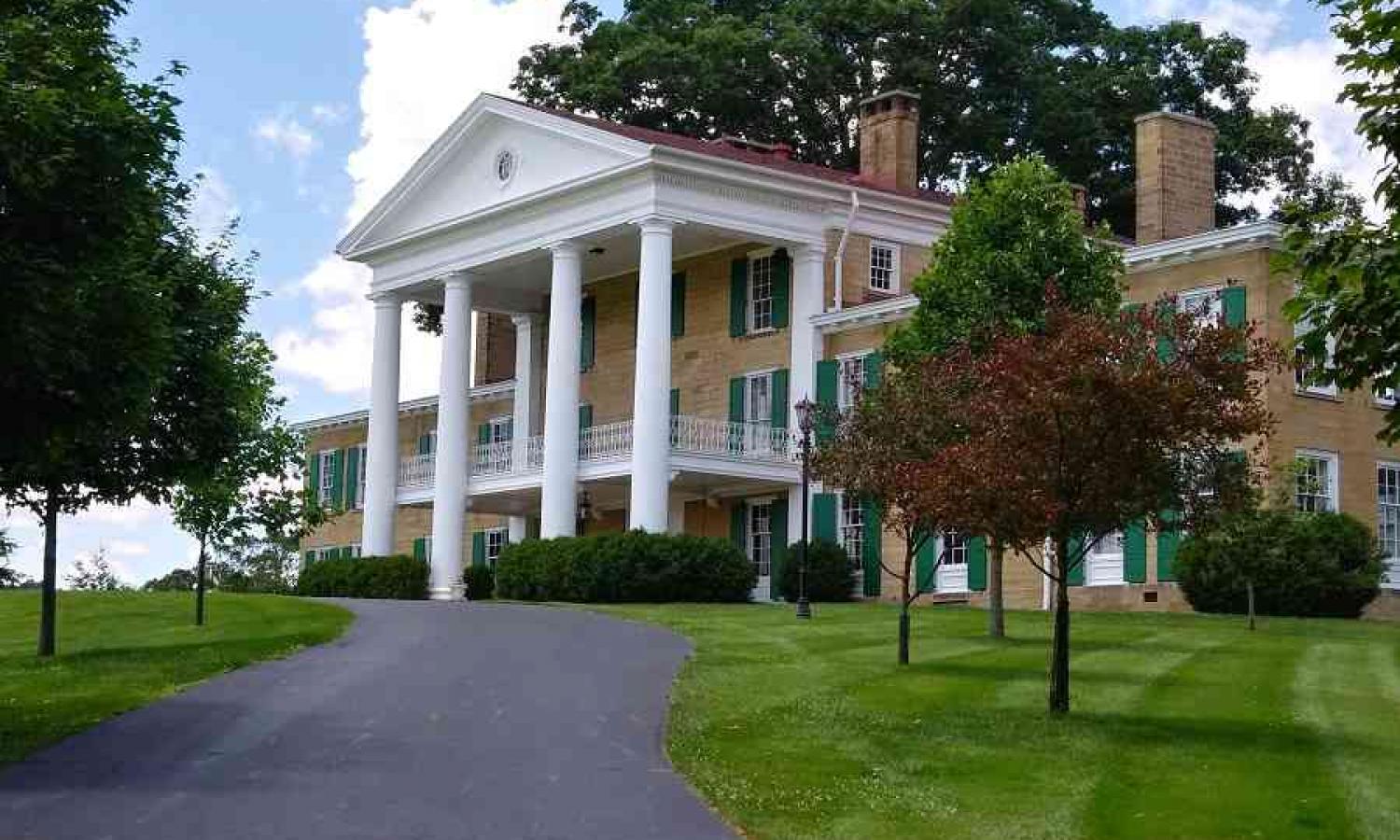 The Bryn Du Mansion dominates the property. The Artist in Residence Cottage sits behind the Mansion.