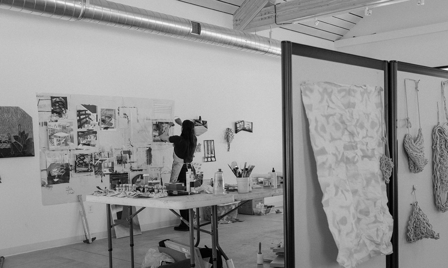Artist-in-Residence working in their studio on 2D work. Photo Credit: xoMe Studio