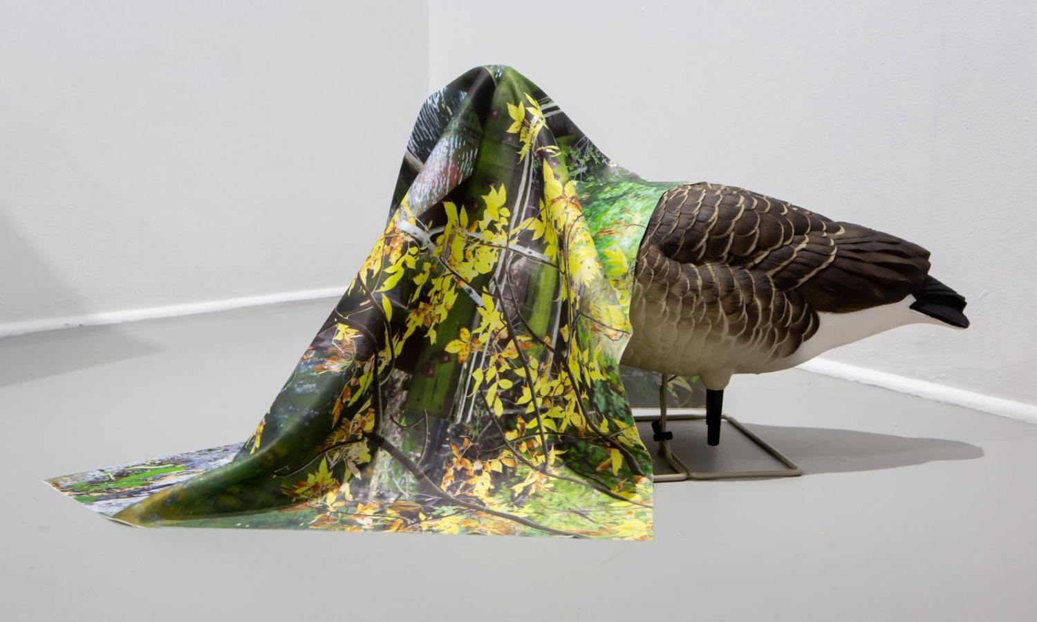 Photograph of a sculptural artwork that depicts a goose covered in cloth.