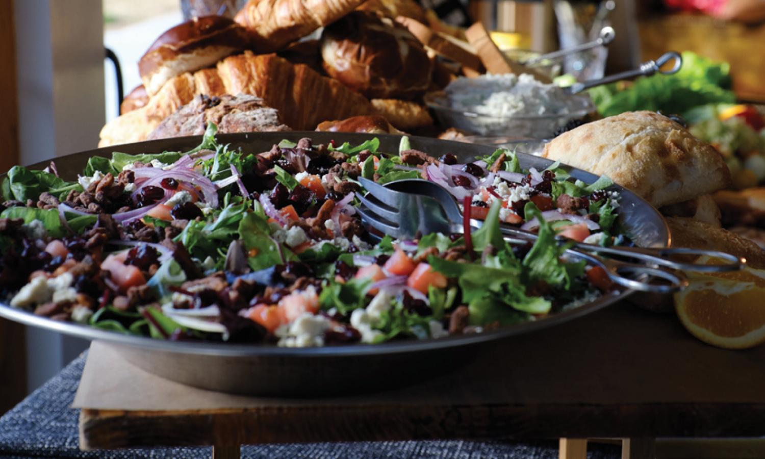 Closeup of a colorful salad in a large food spread
