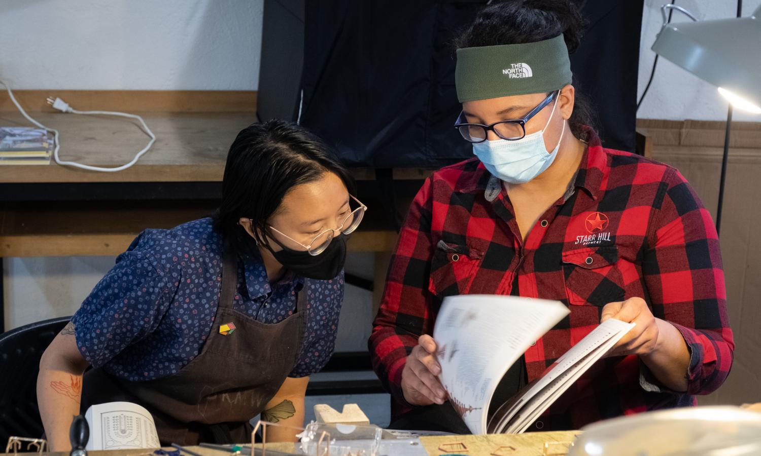 Mia Kaplan and Nancy Sanderson work side by side in the metals studio