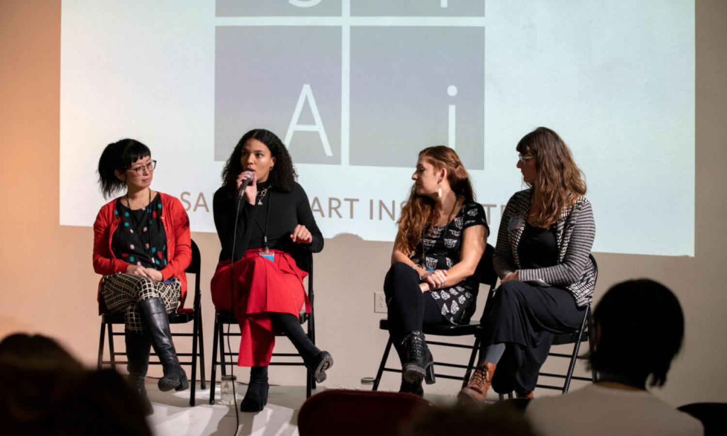 Resident artists presenting their work in a discussion for a public audience.