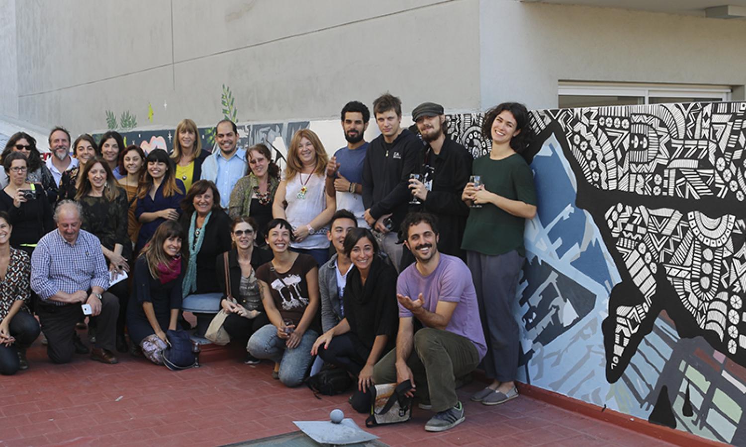 Artists in front of the mural painting project