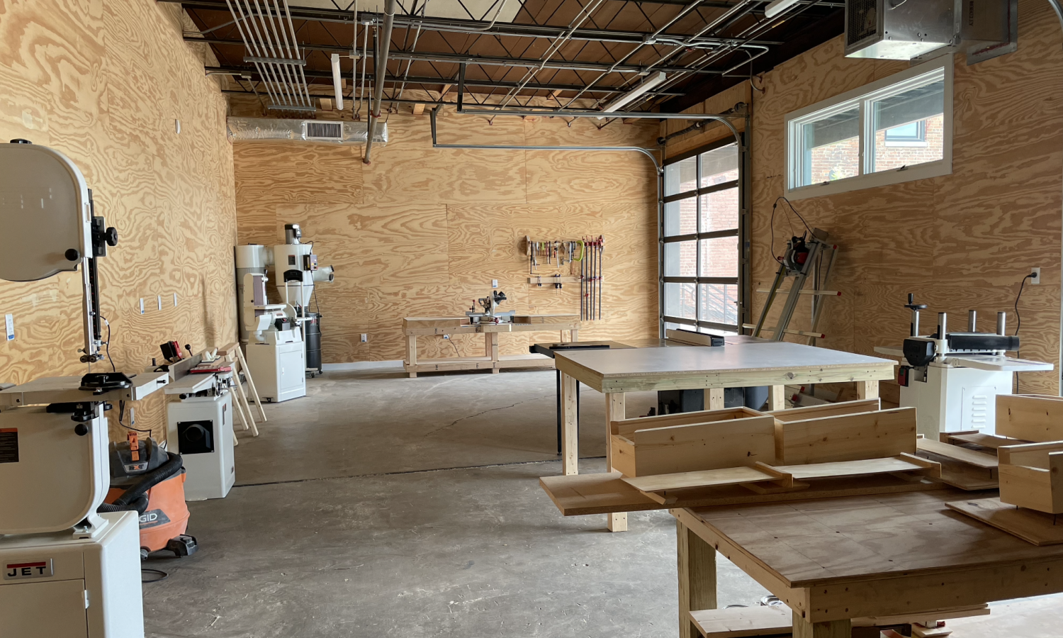 raw wooden walls and equipment within the wood shop