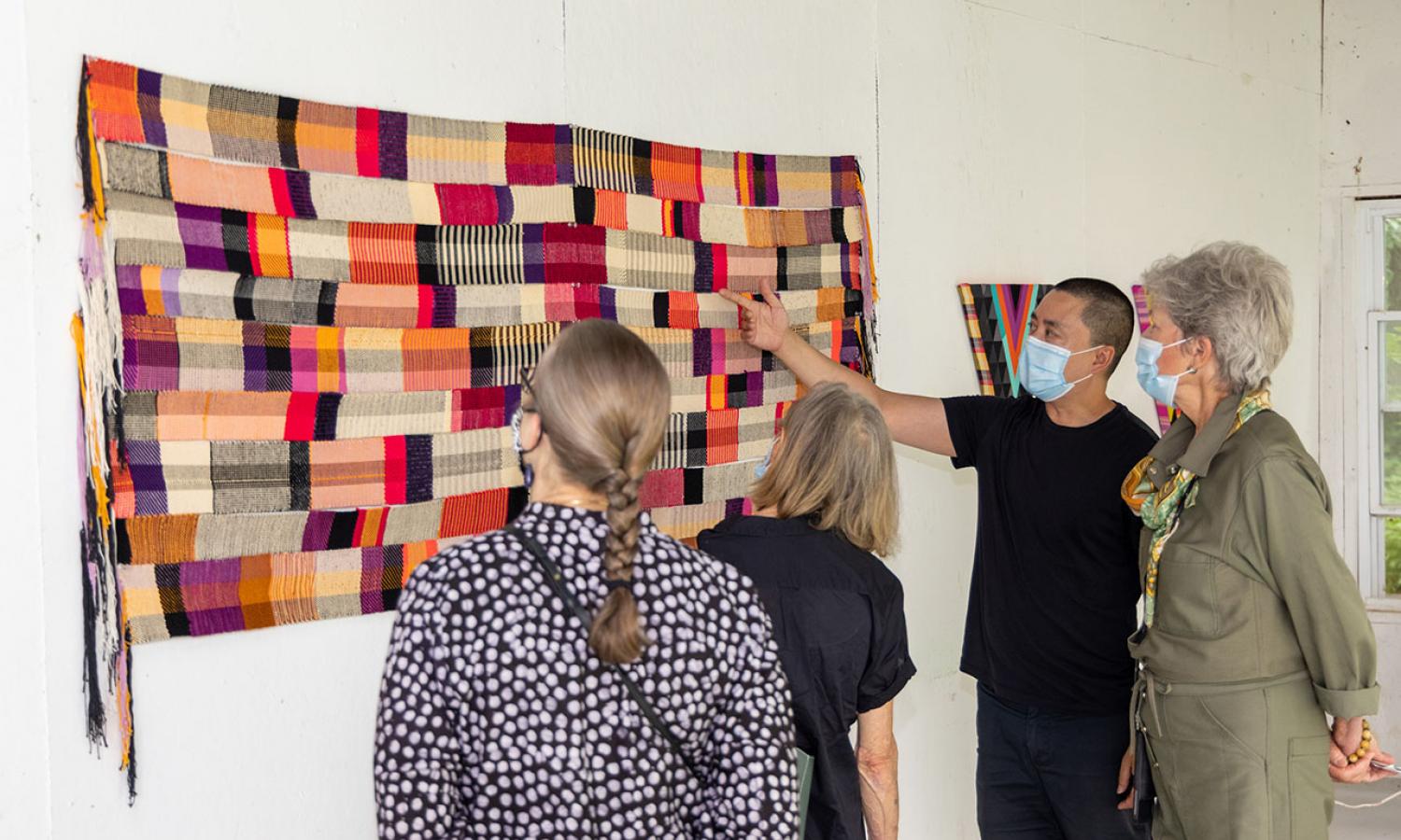 Resident presenting their textile work to an audience