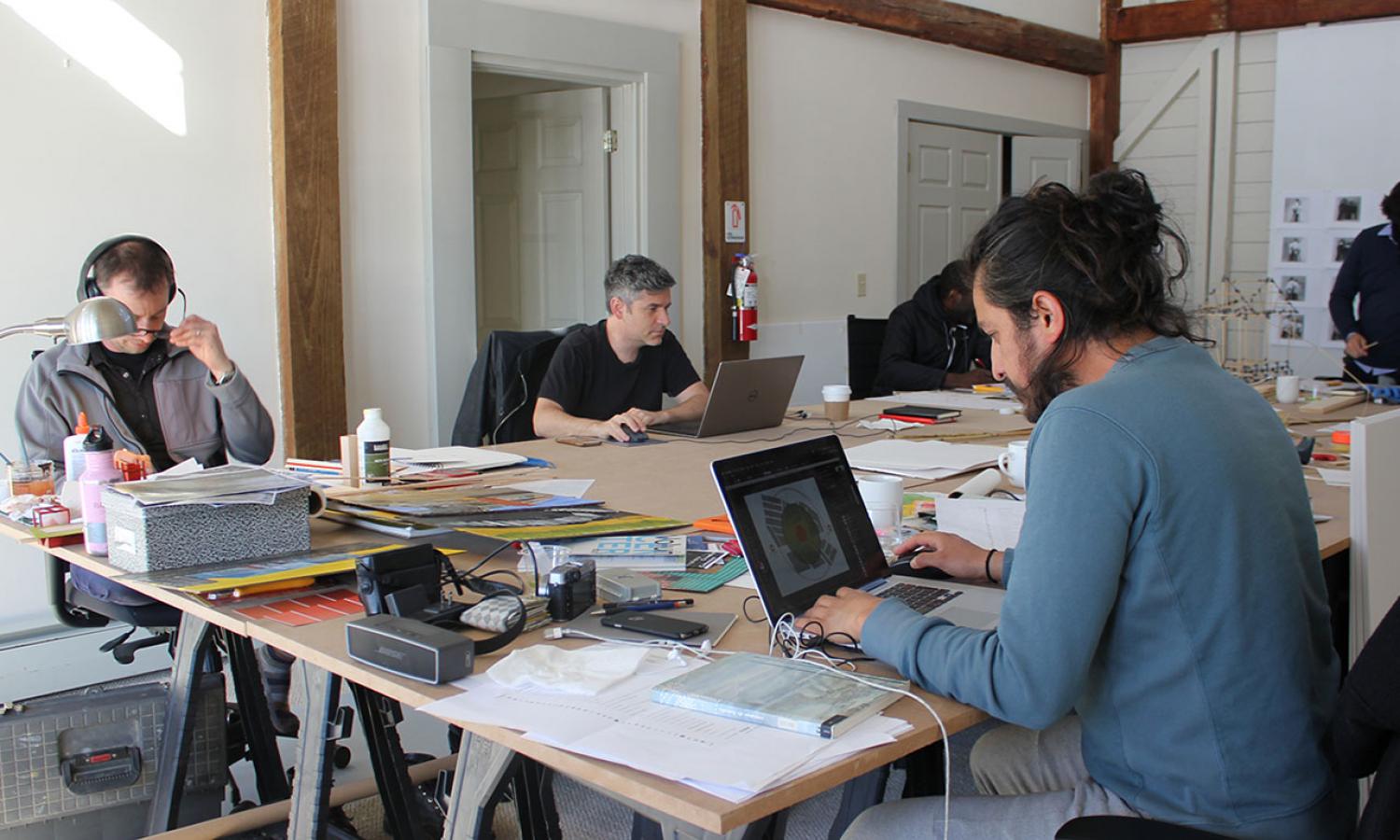 Residents working at shared desk space in Reynolds house