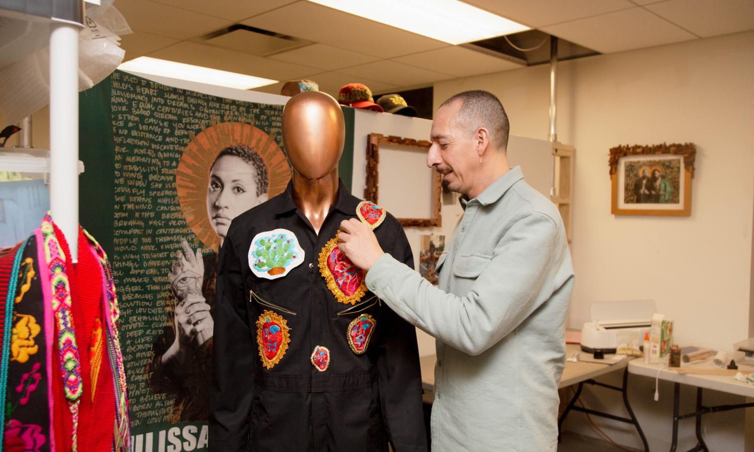 Artist Gabriel Garcia Roman working on a fiber arts work.