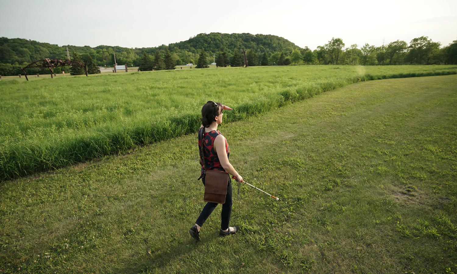 June 2021 Anderson Center Artist-in-Residence Cristina Hartmann strolling the 15-acre Sculpture Garden