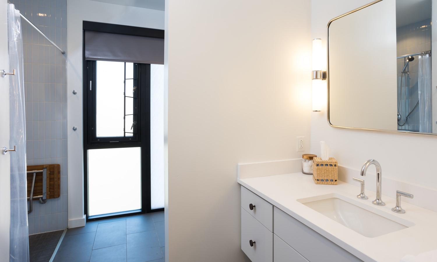 Shared ADA compliant full bathroom with shower only.