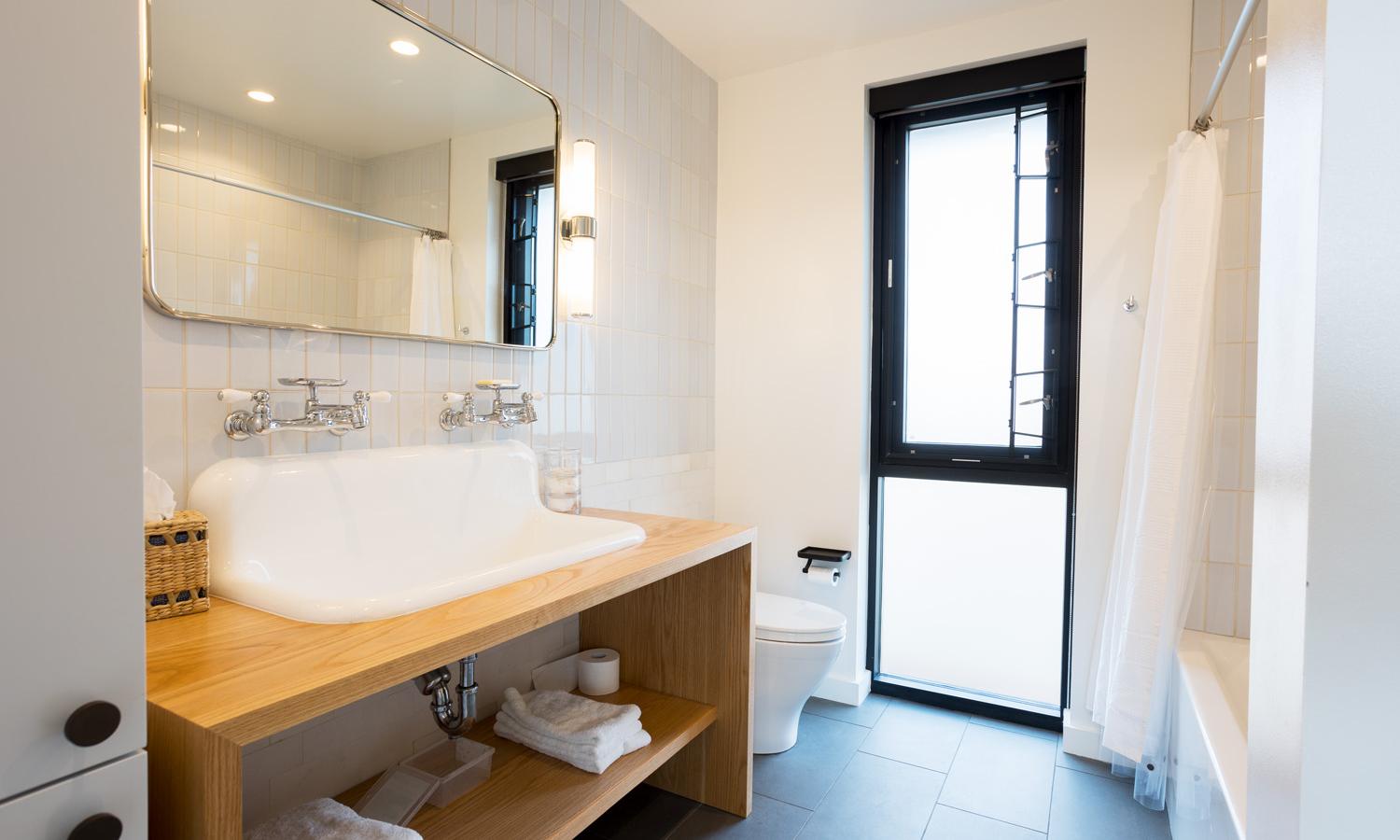 Shared full bathroom with tub and shower. Located on the top apartment floor accessible by stairs only.