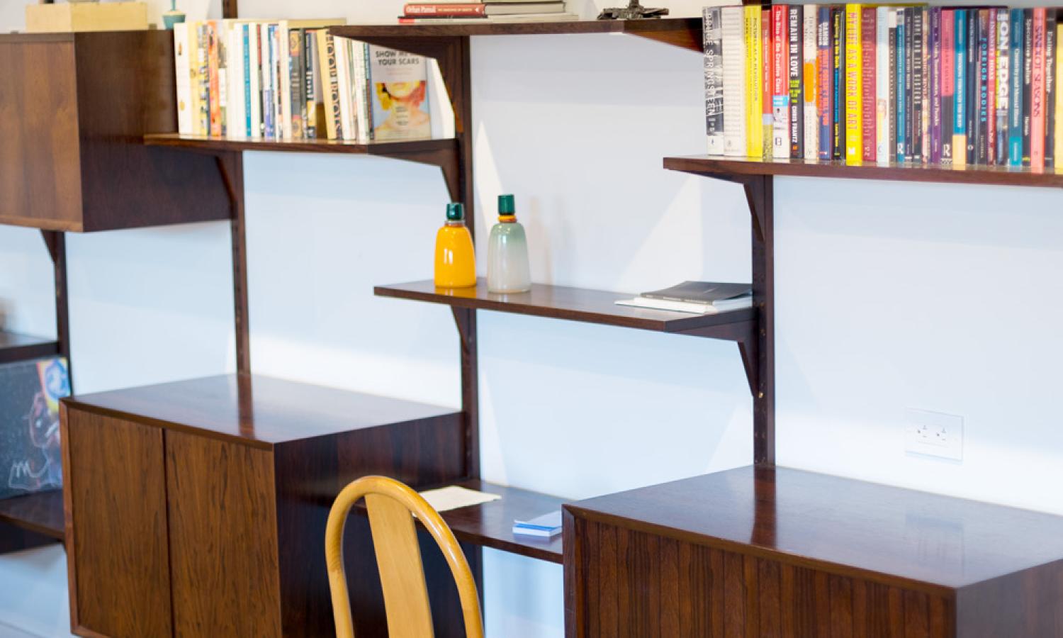Shelves and small working nook within open shared common space. Located on the main apartment level accessible by stairs or elevator.