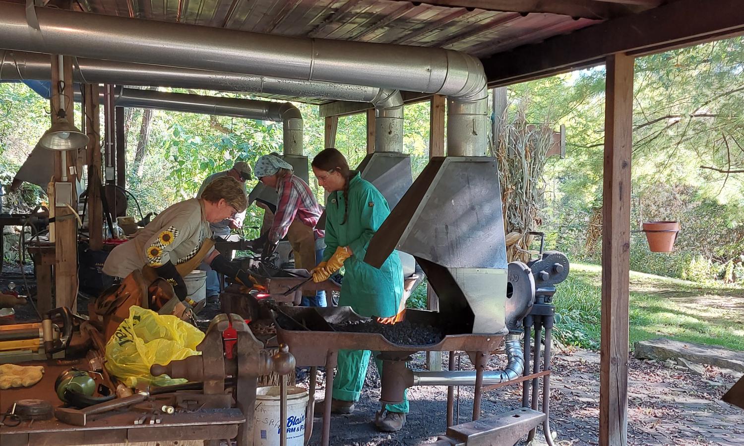 Students at work at the forges in the Blacksmith Barn