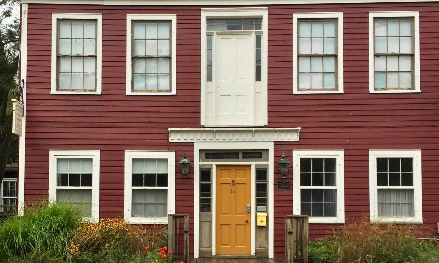 Coach House: Two story building housing private bed and bathrooms for residency