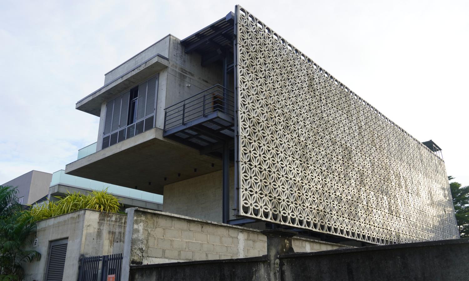 A side view of the G.A.S. Lagos building showing the concrete screen that wraps around the the building.