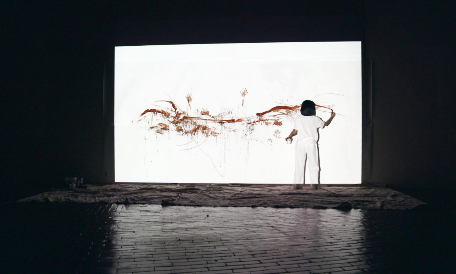 Artist Soyoung working on a large canvas in the Cyclorama