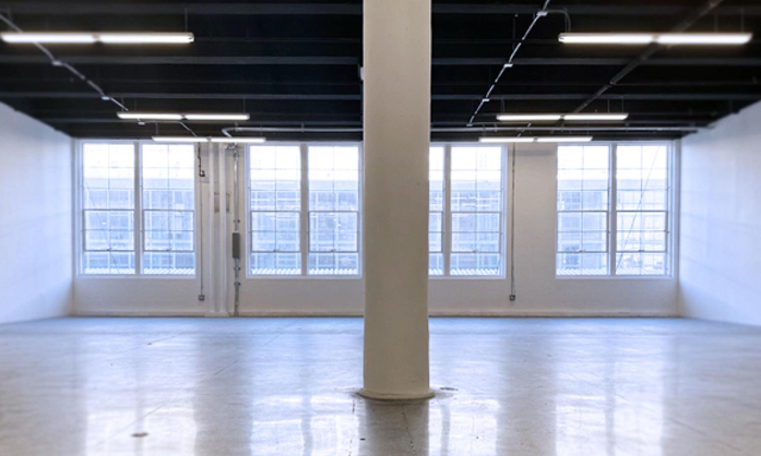 straight view of studio with windows, pillar, walls