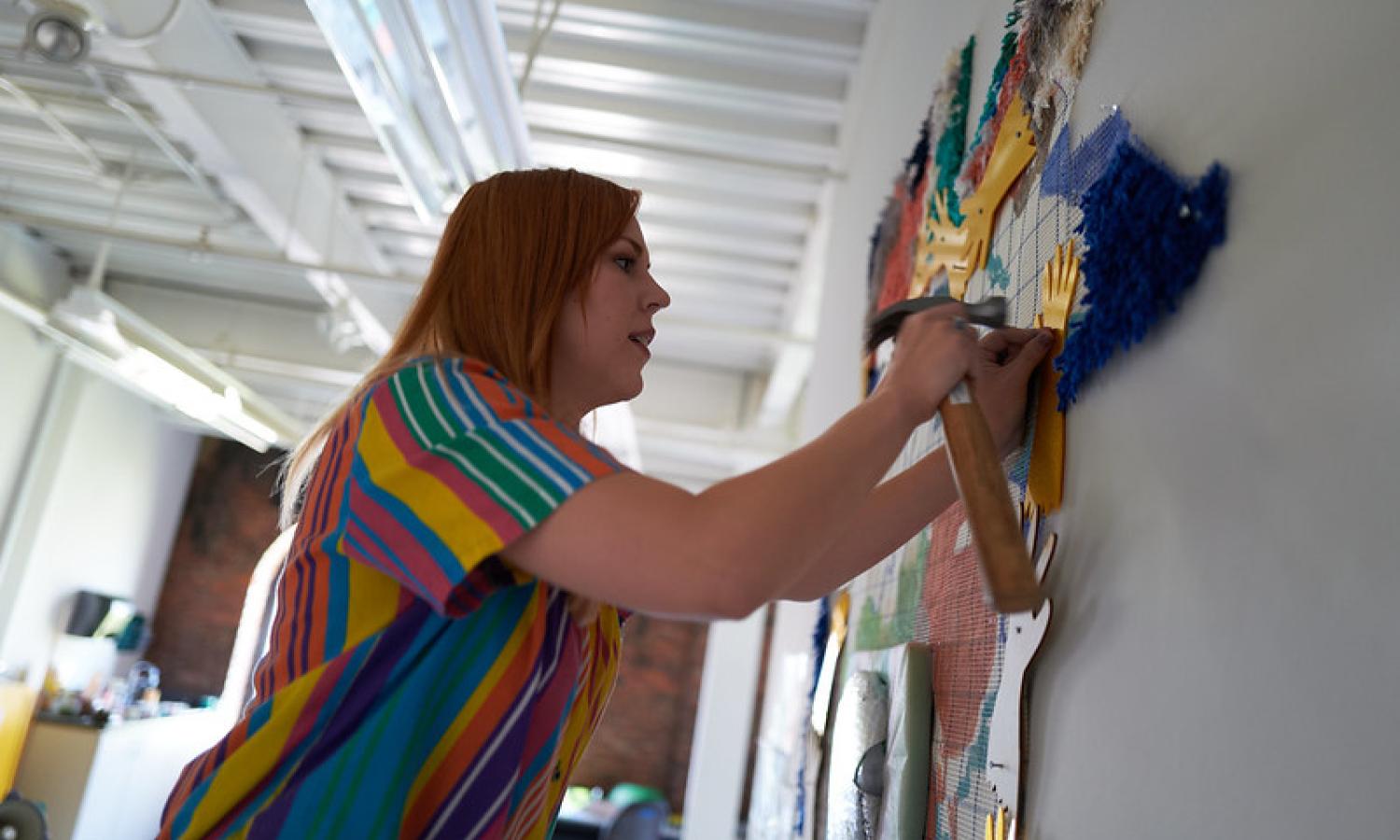 Artist Janet Loren Hill working in her McColl Center studio