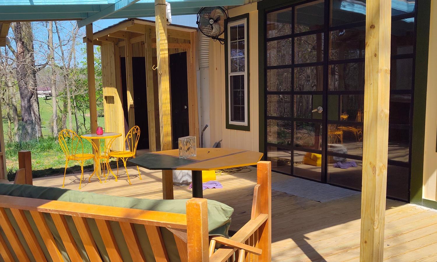 View of entry porch and front doors of live/work studio space, which includes (closed) doors to the toilet and shower rooms