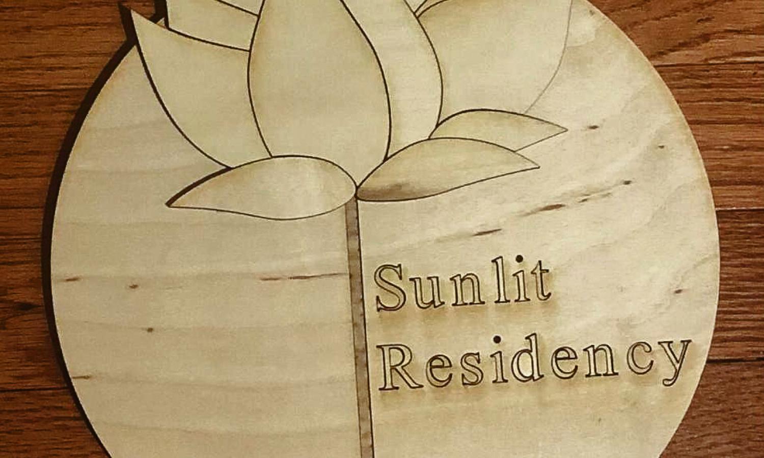 Entry sign with Sunlit logo