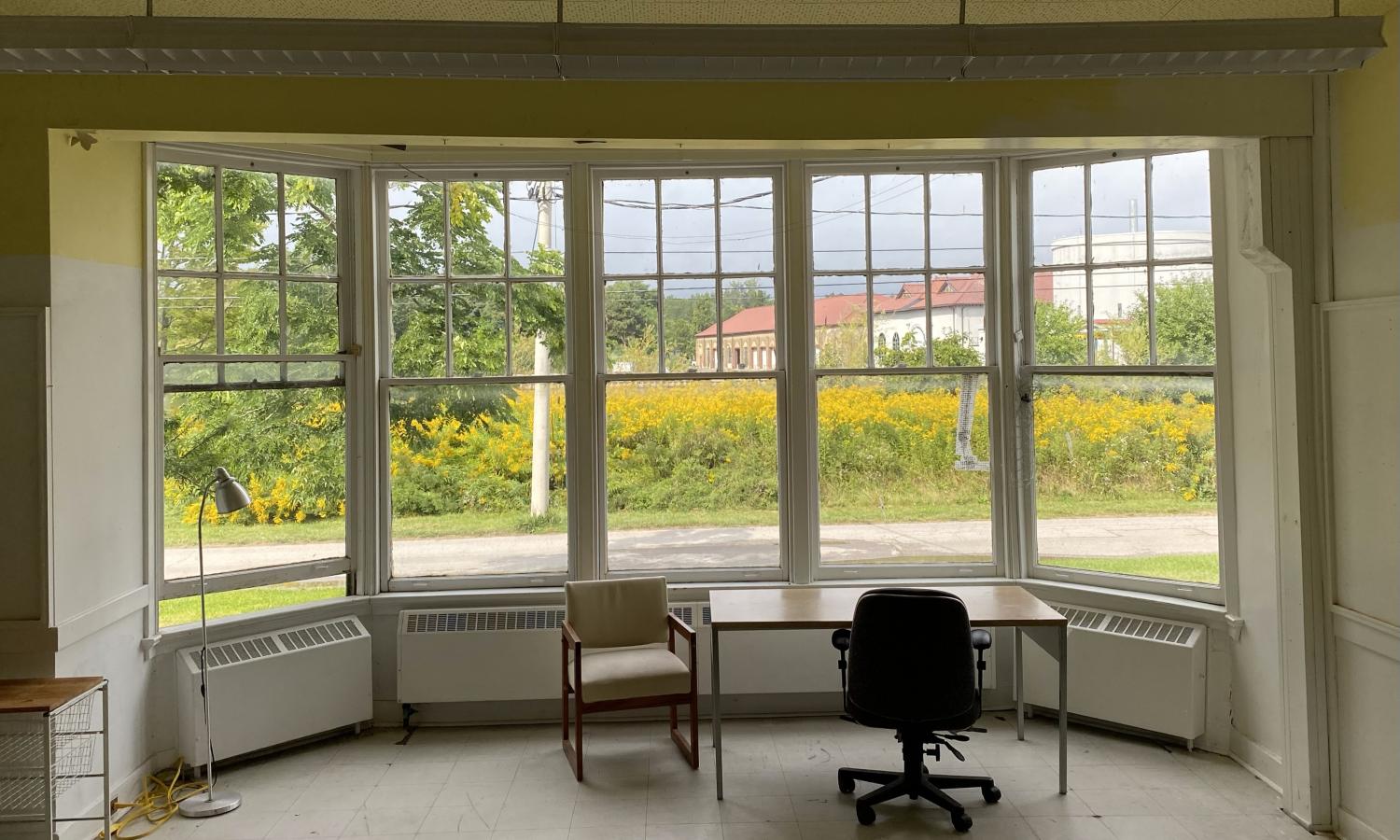 A bright studio facing the Toronto skyline with large windows.