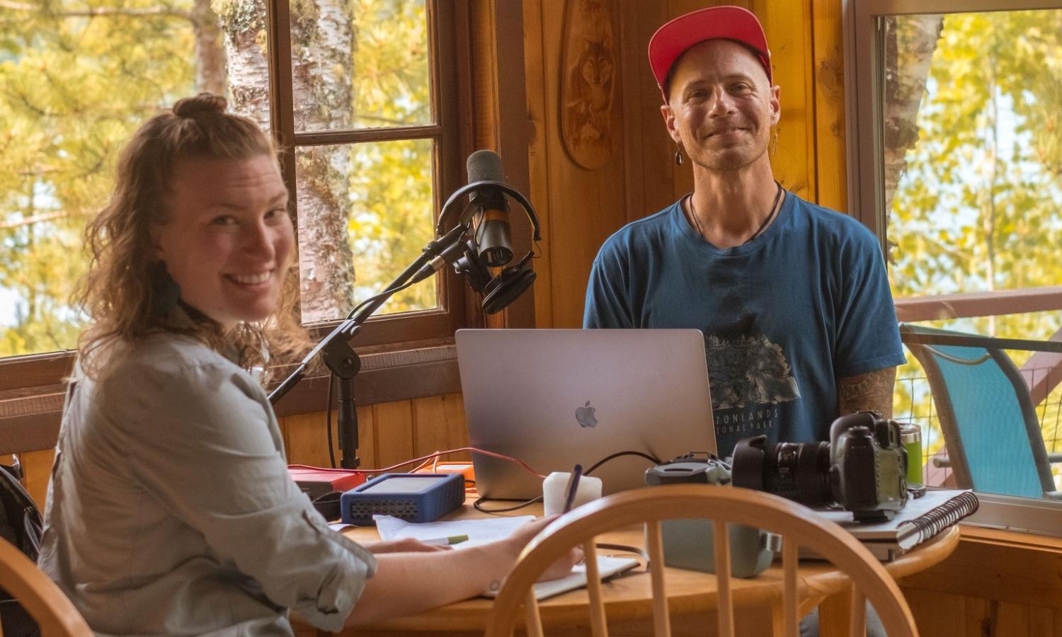 Artists in residence working together in cabin by the lake