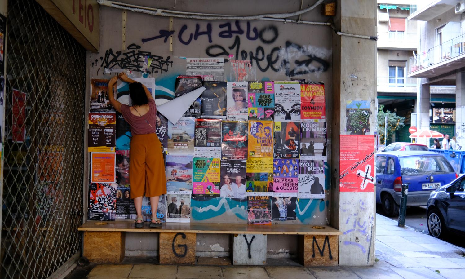 Putting up posters for an exhibition in the local neighborhood.