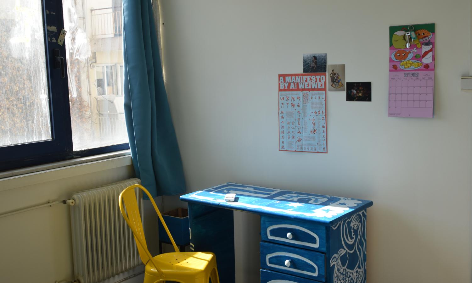 A painted table by a window in the studios