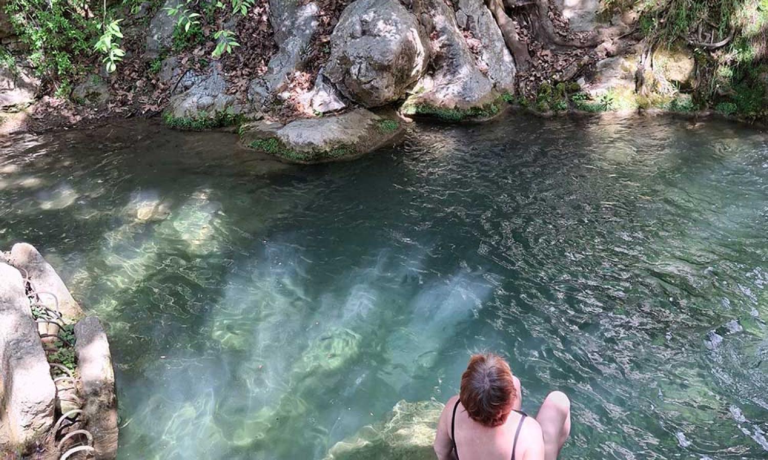 Landscape painter Sanneke Griepink swimming a fresh water mountain pool under a waterfall at the Water and Rock art residency in Thassos, Greece