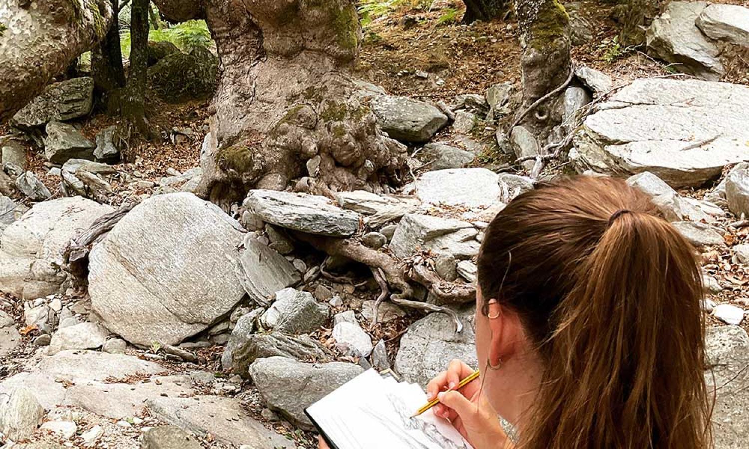 Artist and teacher Alice King sketching in the gorge next to the Water and Rock art residencyy in Thassos, Greece