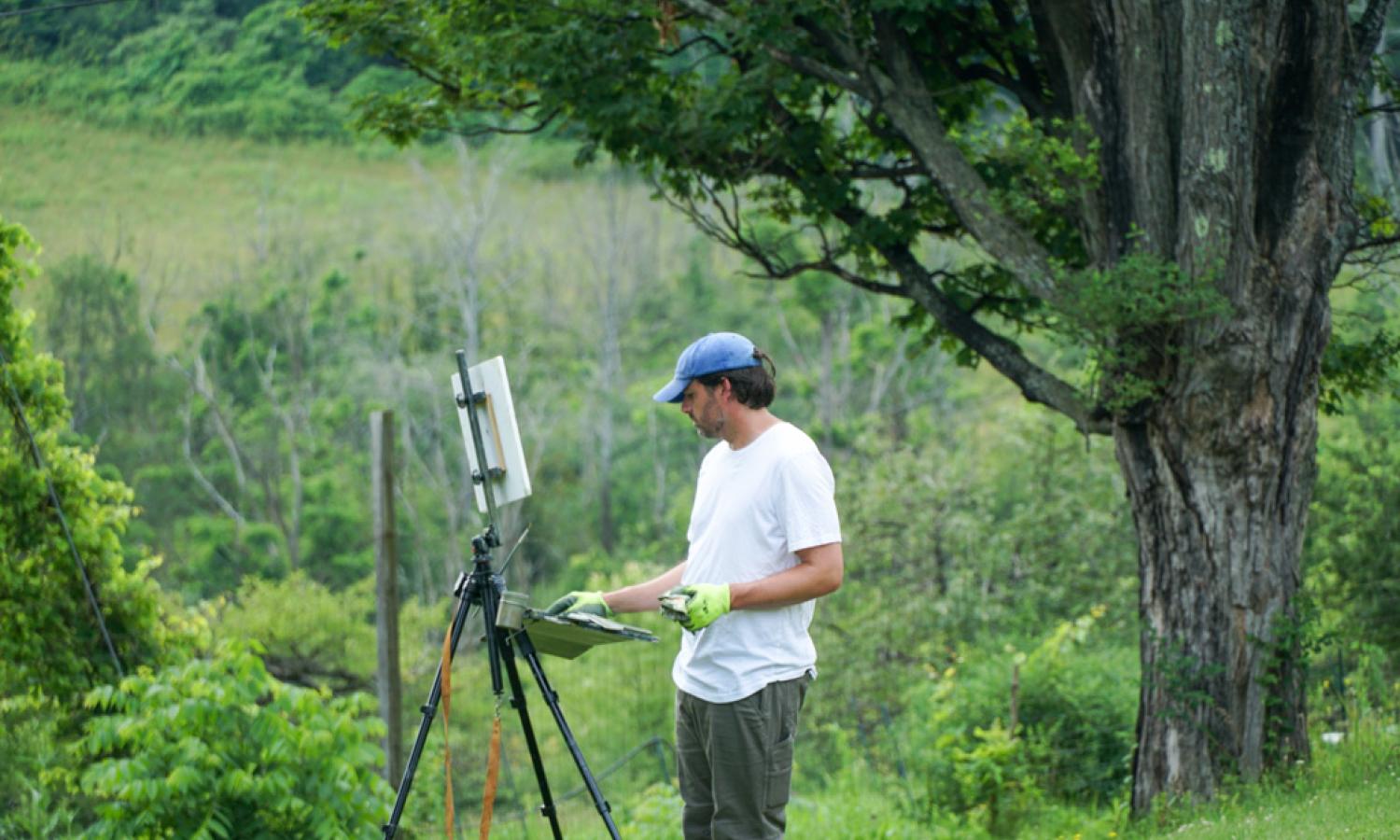 Plein air painter in a field