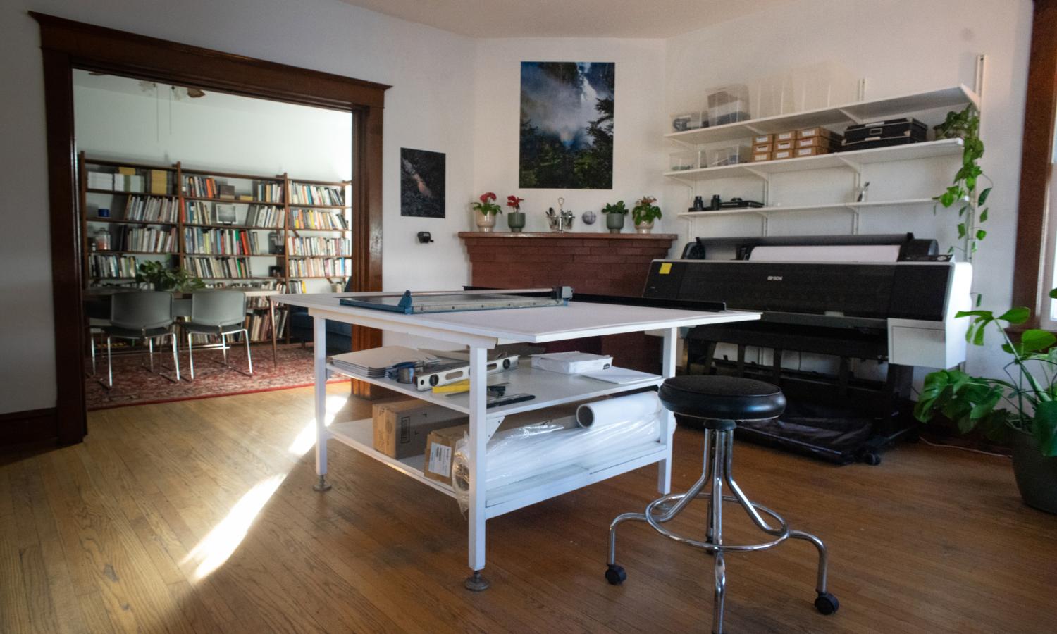 Digital studio with library in the background.