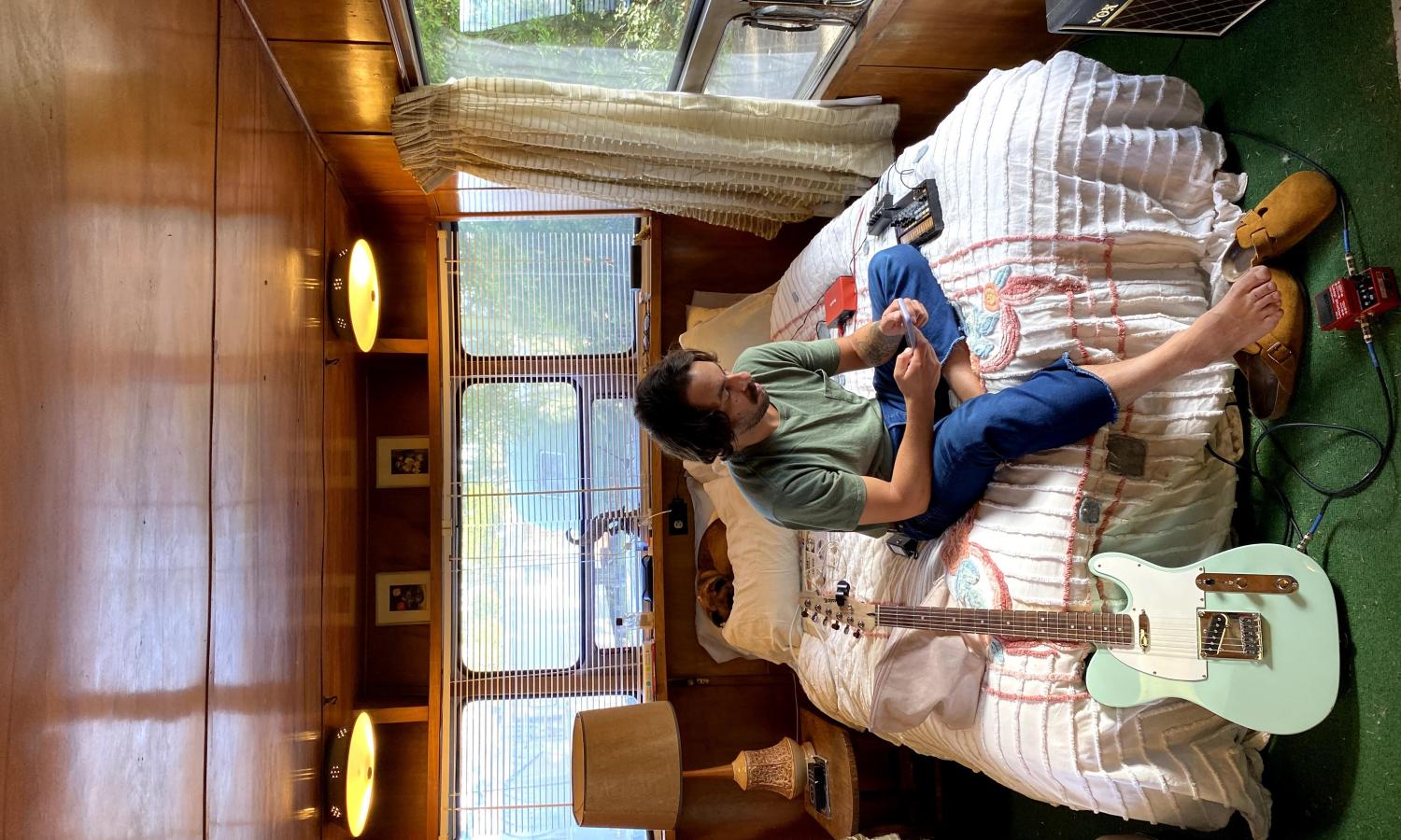 artist in residence lounging in vintage trailer