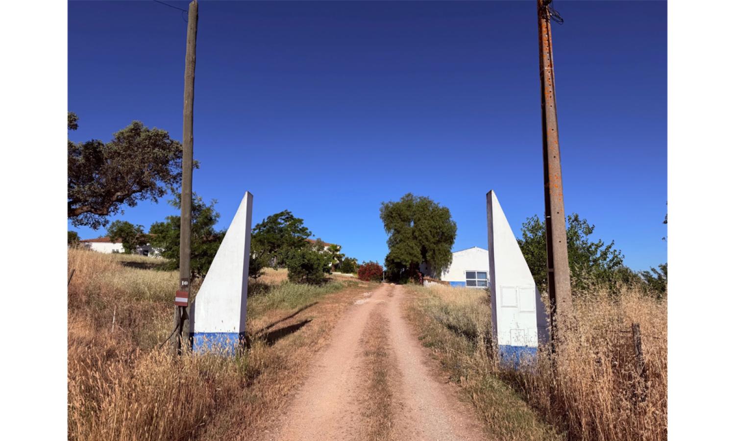 The white and alentejo  blue painted gate to Obras Residencies