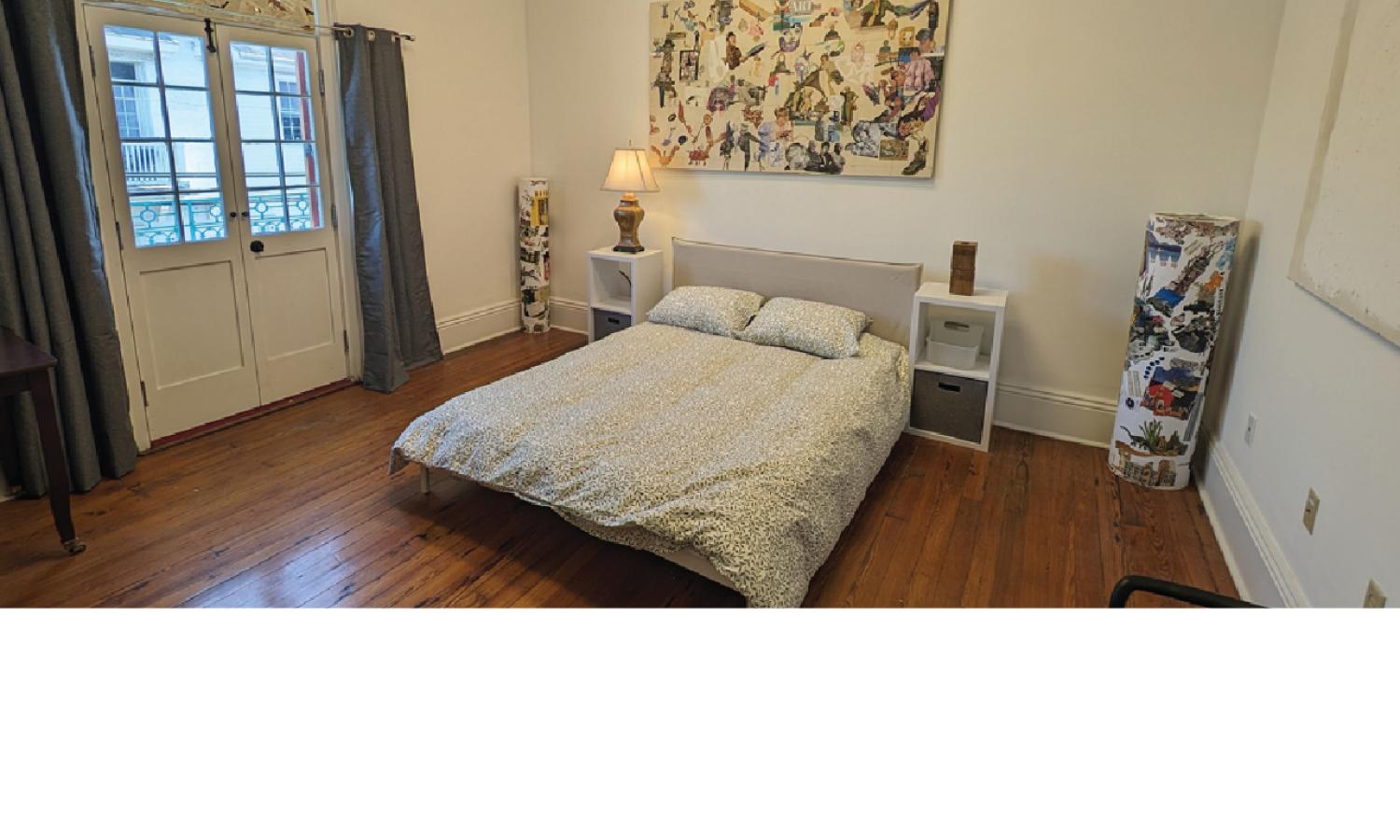 Resident bedroom at Kolaj Institute with a bed, wood floors, balcony doors, bedside tables, and collage artwork on the walls.