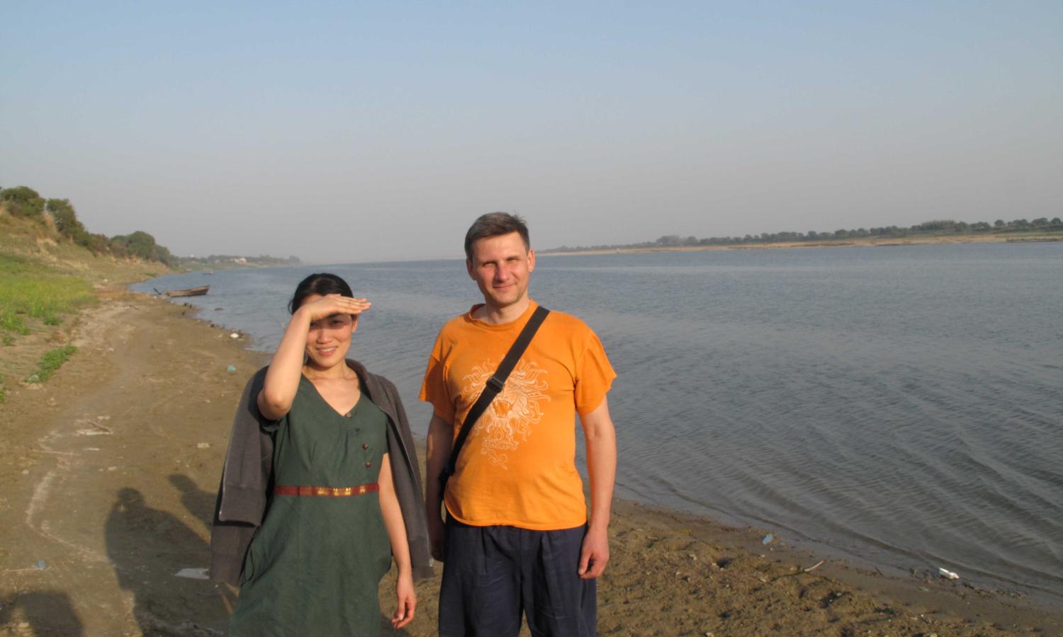 Two residents standing on the banks of the Ganga on NIRMAN's riverside campus